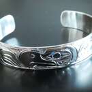 1/2" Silver cuff bracelet, Eagle and Whale design by Paddy Seaweed